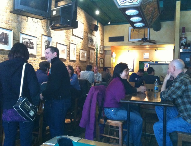 Groups of people at tables at the Brehon Pub for a Meetup.