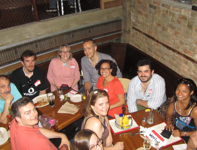 Group photo of skeptics seated at tables from above
