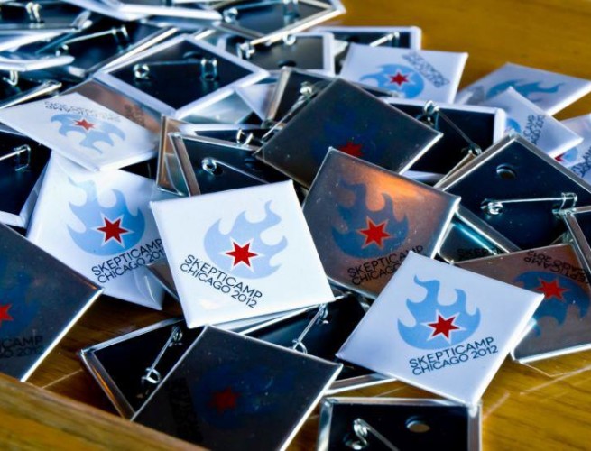 closeup of square pins with the Chicago Skepticamp logo