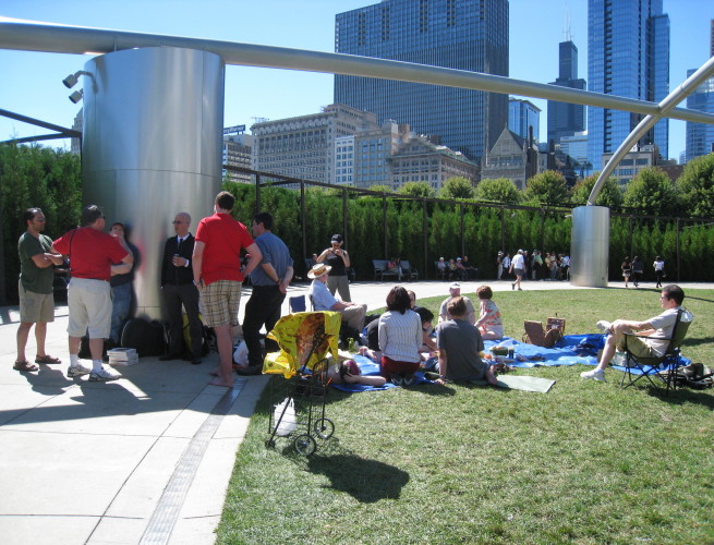 a group of skeptics stand and lounge with George Hrab in Grant Park